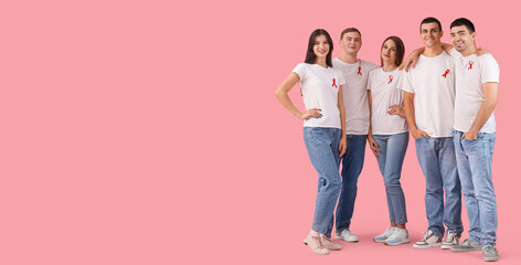 Young people with red ribbons on pink background with space for text. World AIDS Day - obrazy, fototapety, plakaty