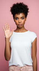 young girl in a T-shirt shows a stop sign with her hand