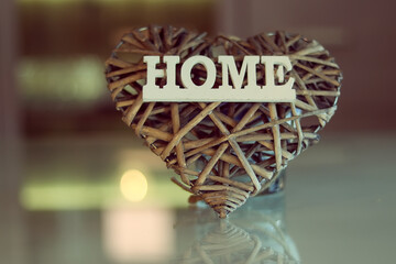 Fototapeta na wymiar Home Sweet Home. Stringed Wooden Heart Shaped Ornament with Home Sign