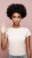 young girl in a T-shirt shows a stop sign with her hand