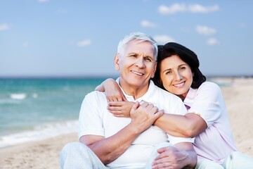 Senior happy couple have fun on the beach