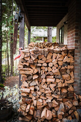 Piles of cut and split firewood, ready for winter, piled behind a mountain house.  Whistler BC, Canada.