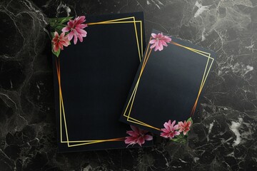Blank invitation cards on black marble background, top view. Space for text