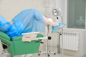 Gynecological checkup. Woman lying on examination chair in clinic, closeup