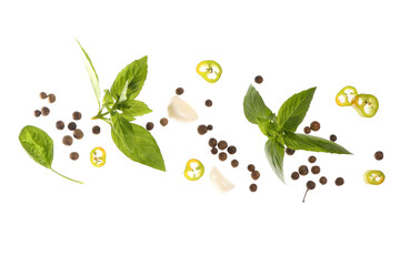 Obraz premium Flying spices and basil on white background