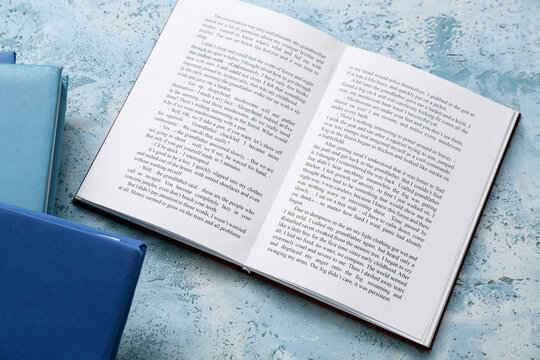 Open book on light blue table