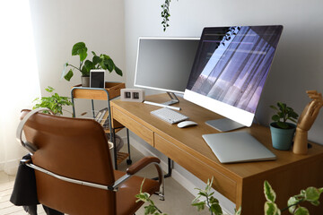 Programmer's workplace with computer monitors in light office