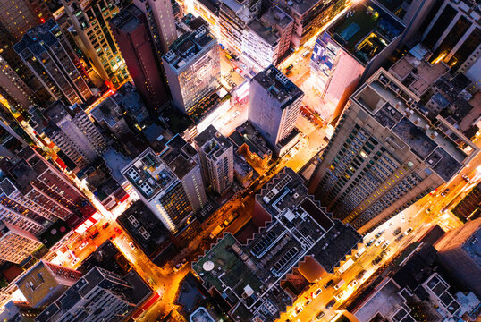 Aerial top view of downtown district buildings in night city light © BullRun