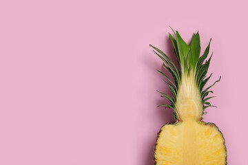 Half of ripe pineapple on pale pink background, top view. Space for text - obrazy, fototapety, plakaty
