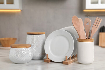 Set of different kitchenware on white table at home