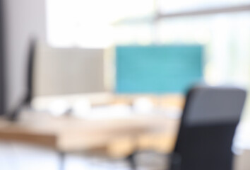 Blurred view of modern office with computers