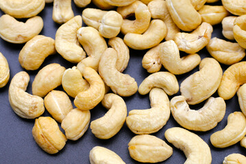Cashew nuts on dark background.