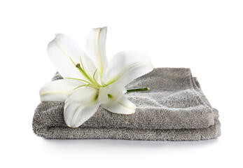 Obraz na płótnie Canvas Clean towel and beautiful lily flower on white background