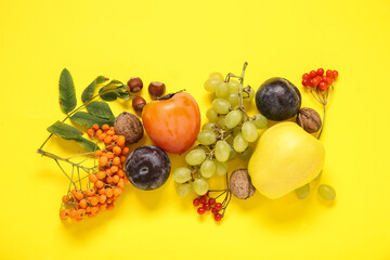 Different fresh fruits on yellow background