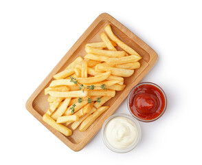 Wooden board of tasty french fries with sauces on white background