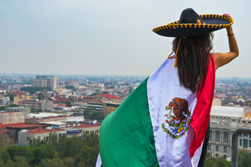 Woman with flag of Mexico, celebrating Mexican Independence Day.September 16. Mexican Independence Day.