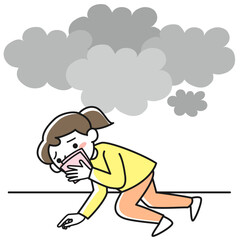 火災時に口と鼻を覆って低い姿勢で避難する若い女性