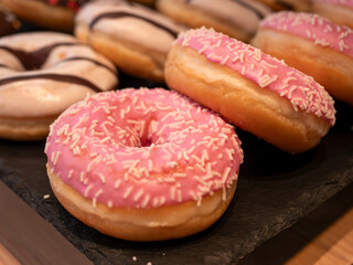 Tasty Pink and Vanilla Glazed Donuts in a Pastry Shop