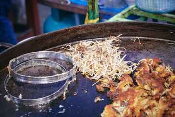 In a large pan, fry the oysters and bean sprouts.Seafood Thailand
