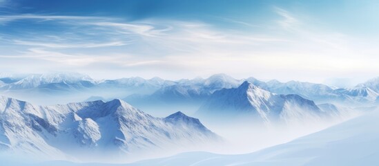 Fototapeta na wymiar Cloudy sky over a wintery mountain scene