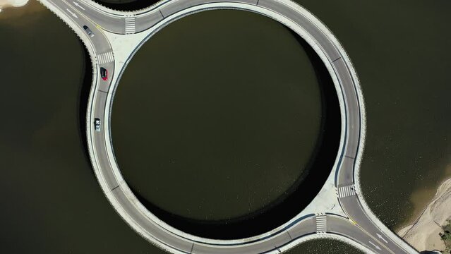 Cars Crossing Circular Bridge Over Laguna Garzon Uruguay, Bird's eye Drone Rotate