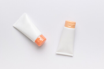 Two tubes of cream on a white background. The concept of body care.