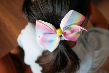 Beautiful ribbon is tied on a child hair 