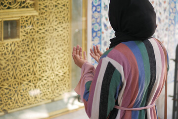 rear view of women praying at mosque 
