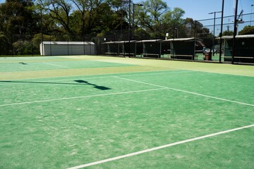 synthetic court in a park in summer, tennis court with a net