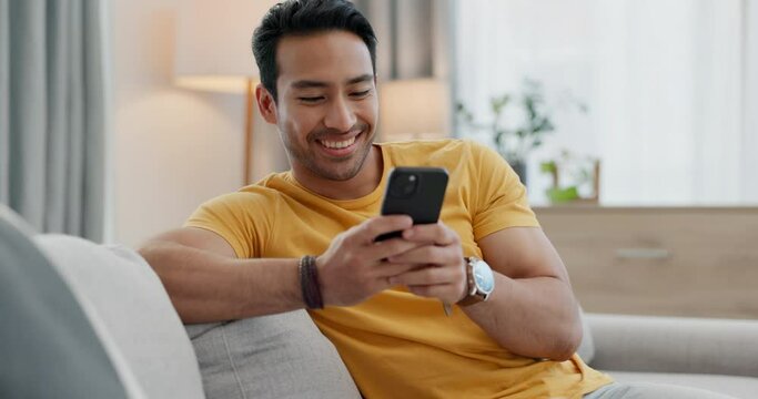 Home smartphone, smile and relax man typing, texting and reading app post, social network blog or media news, site or email. Lounge couch, happiness and person research mobile info, story or article