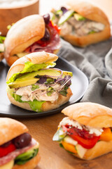Healthy sandwich rolls rest on a table top.