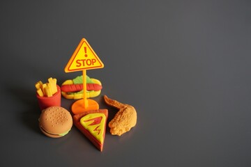 Closeup image of STOP signboard and junk foods. Stop eating unhealthy food concept. - obrazy, fototapety, plakaty