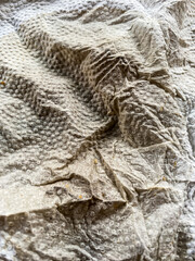 White color creased paper tissue spilled with coffee background texture,