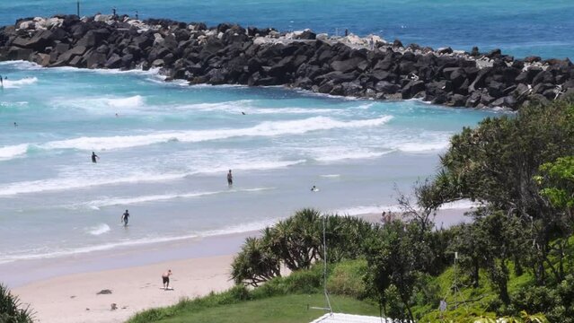 People enjoying a sunny day at Snapper Rocks, Coolangatta beach.