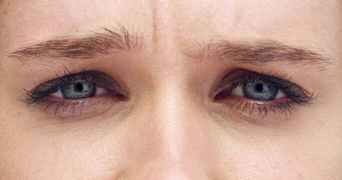 Woman, eyes and closeup with frown, face and sad with depression, mental health or anxiety. Person, macro zoom and stress with eyebrow, worry and lashes with wellness for vision, eyesight or retina