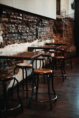 Wooden chair and table set on the industrial and rustic coffee shop. Portrait or vertical.
