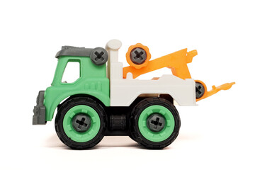 Side view of DIY plastic towing truck toy isolated on white background