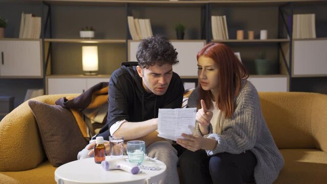 Sick couple reading prospectus.