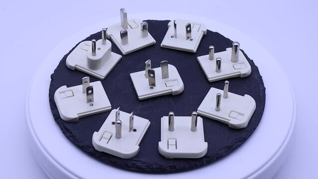 A collection of electrical socket adapters for different countries.