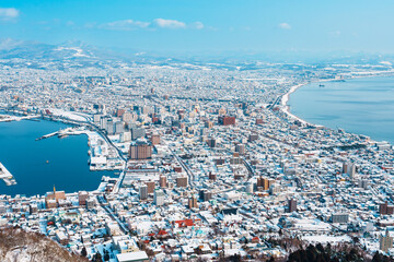 Beautiful landscape and cityscape from Hakodate Mountain with Snow in winter season. landmark and...