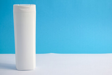 White Bottle shampoo blank for mock up with blue background, beauty health care mockup bottle.