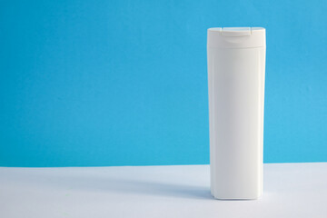 White Bottle shampoo blank for mock up with blue background, beauty health care mockup bottle.