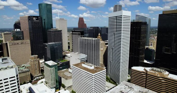 Cityscape of downtown Houston, sunny day in Texas, USA - pull back, drone shot