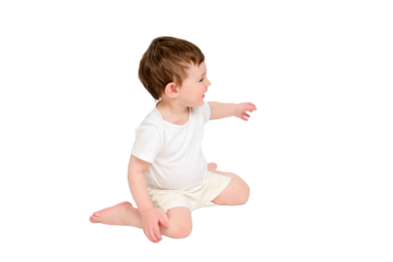 A happy baby is sitting on a studio, isolated on white background. Full-length portrait of a smiling child, isolated on white background. Kid aged about two years (one year nine months)