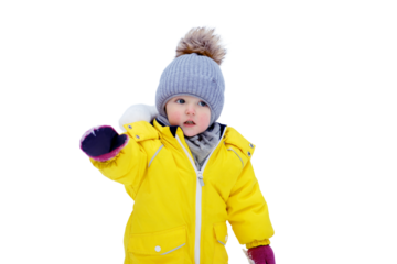 Happy toddler baby is playing in a yellow snowsuit, isolated on white background. Child boy in warm clothes walks in snowy winter park, isolated on white background. Kid aged one year six months