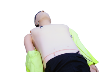 First aid training - CPR on a mannequin, isolated on white background. Resuscitation to a training dummy in the emergency room