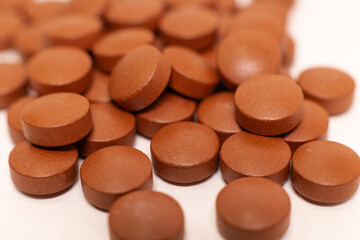 Obraz na płótnie Canvas Close up of colored pills on white tabletop.