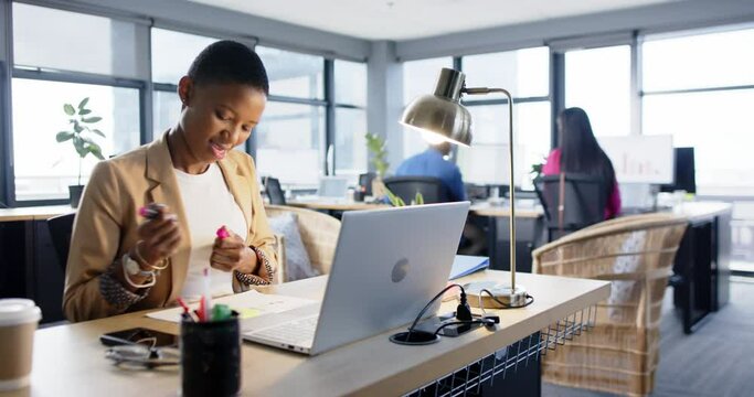Portrait of african american businesswoman using laptop in office, slow motion, copy space