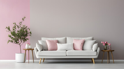 White sofa and armchair with pink cushions against grey wall. Scandinavian interior design of modern living room