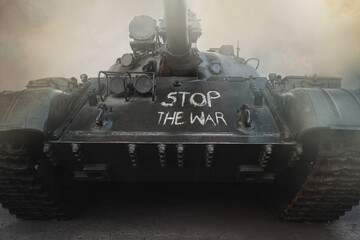 stop war the chalk inscription on the tank in fire and smoke. Anti-war concept.